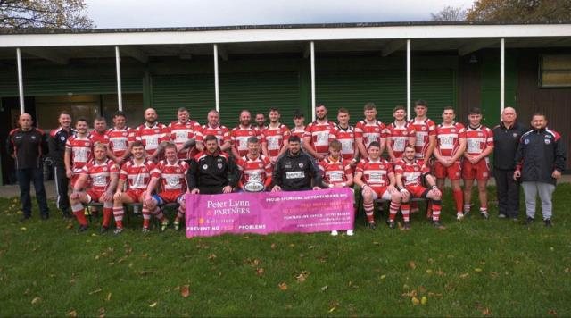The Pontardawe RFC squad with their sponsor's banner outside the clubhouse